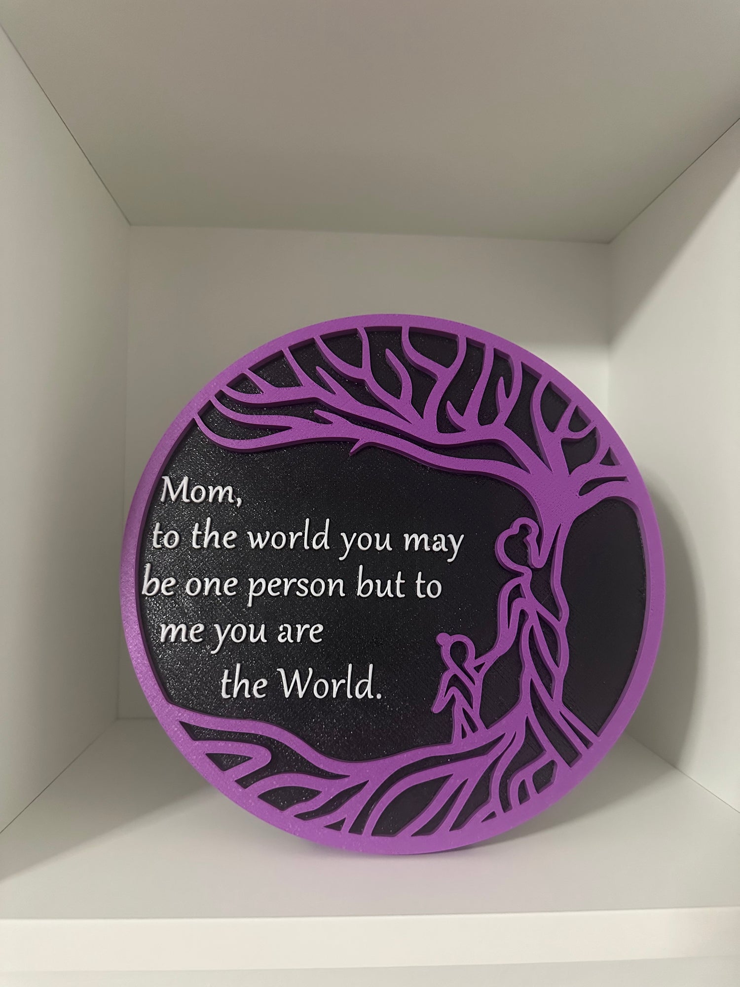 Round purple and black plate that says Mom you are the world