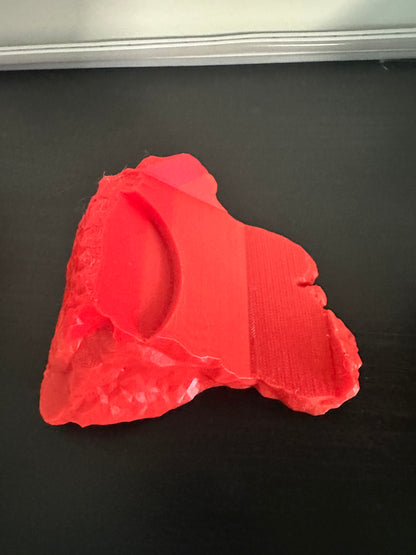 3D-printed red Thor hammer base on a black background