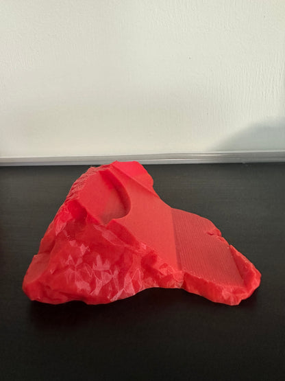 3D-printed red Thor hammer base on a black background